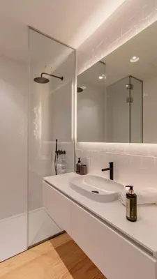 a white bathroom with a sink and a mirror at Almada 551 by LovelyStay in Porto