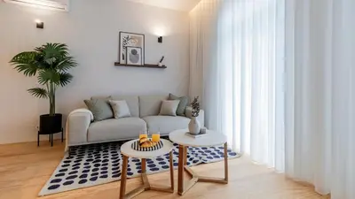 a living room with a couch and two tables at Almada 551 by LovelyStay in Porto
