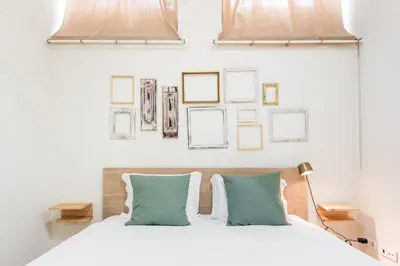 a bedroom with a white bed with green pillows at GuestReady - Breyner Stonewall Haven in Porto