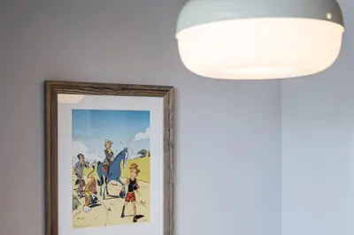 a painting hanging on a wall next to a light fixture at GuestReady - A warm city refuge in Cedofeita in Porto