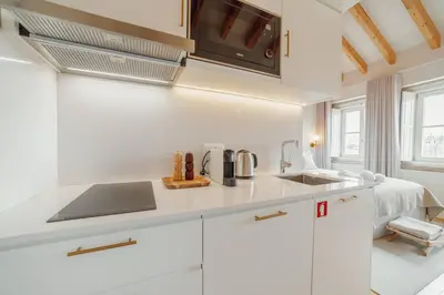 a white kitchen with a sink and a microwave at Clerigos Boutique Apartments by Hosty in Porto