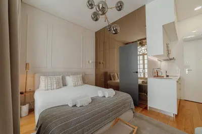 a bedroom with a bed with two towels on it at Clerigos Boutique Apartments by Hosty in Porto