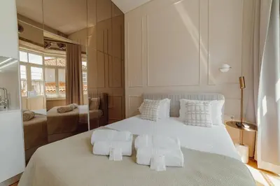 a bedroom with a large white bed with white pillows at Clerigos Boutique Apartments by Hosty in Porto