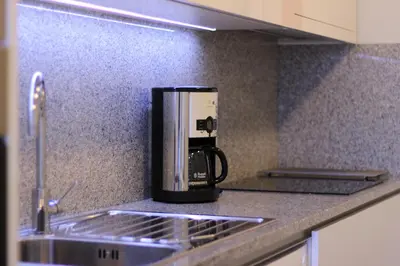 a coffee maker sitting on a counter in a kitchen at Apartamento em Monsanto - Porto in Porto