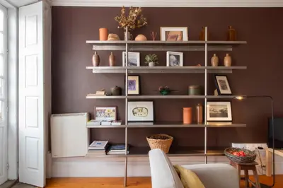 a living room with shelves filled with vases at Porto 61 - Bright 2BR w/ Balcony by LovelyStay in Porto