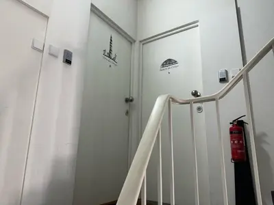 a hallway with stairs and a door with stickers on the wall at Urban Views - ML Apart Inspired by Palácio de Cristal in Porto