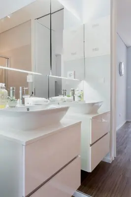 a white bathroom with two sinks and a mirror at Urban Views - ML Apart Inspired in Serralves in Porto