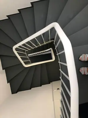 a spiral staircase in a room with a black ceiling at Urban Views - ML Apart Inspired in Serralves in Porto
