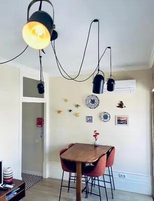 a dining room with a wooden table and chairs at Stylish Flat City Center in Porto