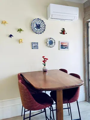 a dining room with a wooden table and chairs at Stylish Flat City Center in Porto