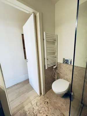 a bathroom with a toilet and a glass shower door at Stylish Flat City Center in Porto