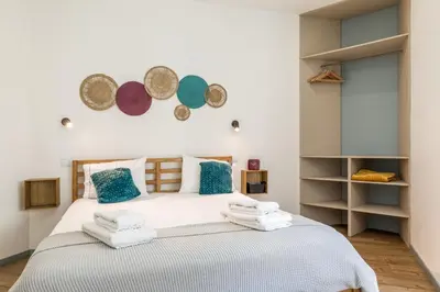 a bedroom with a bed with towels on it at Alma Bonfim Apartments in Porto