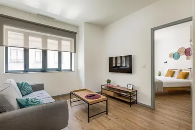 a living room with a couch and a bed at Alma Bonfim Apartments in Porto