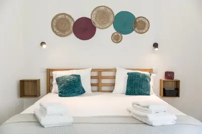 a bedroom with a bed with towels on it at Alma Bonfim Apartments in Porto