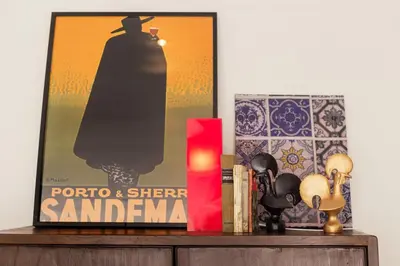a shelf with a movie poster and a book at Oporto Chic & Cozy Studio Apartments in Porto