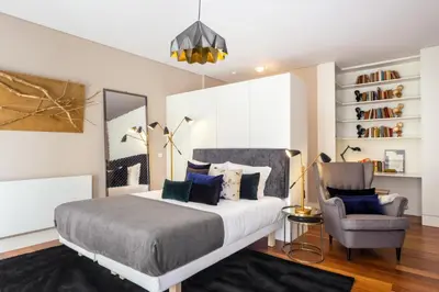 a bedroom with a bed and a chair at Oporto Chic & Cozy Studio Apartments in Porto
