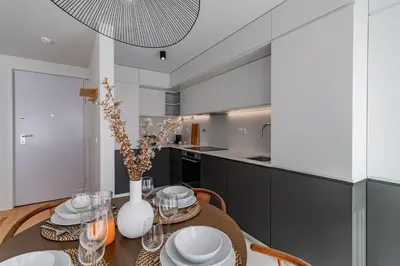 a kitchen and dining room with a table and chairs at João das Regras 321 by LovelyStay in Porto