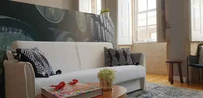 a living room with a white couch and a table at Toctoc Studio in Porto