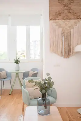 a white living room with stairs and a blue chair at Liiiving in Porto - Secret Grove Mezzanine in Porto