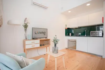 a white bedroom with a bed with two towels on it at Liiiving in Porto - Secret Grove Mezzanine in Porto