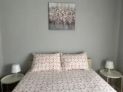 a bedroom with a bed and two tables with lamps at Vicky Porto in Porto