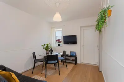 a bedroom with a window with a table and chairs at Casa São Lourenço in Porto