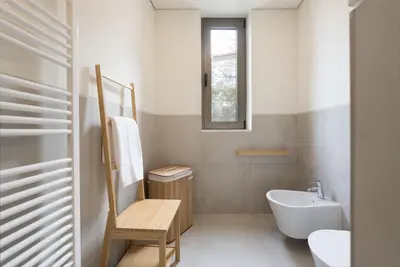 a small bathroom with a sink and a toilet at AgapeStay Family House in Porto