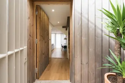a hallway of a house with wooden walls at AgapeStay Family House in Porto