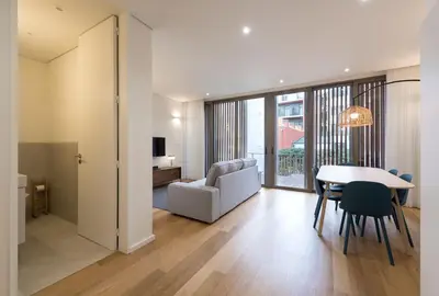 a living room with a table and a chair at AgapeStay Family House in Porto
