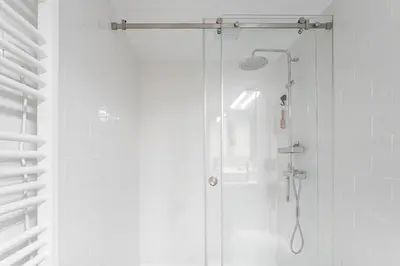a shower with a glass door in a bathroom at GuestReady - The perfect haven near St. Catarina in Porto