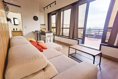 a living room with a couch and a large window at Ninho 424 in Porto