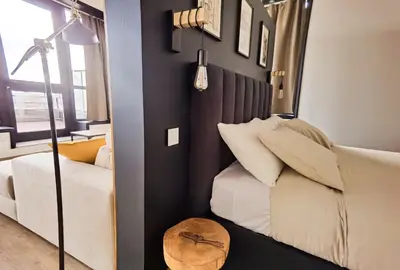 a bedroom with a bed and a chair and a table at Ninho 424 in Porto