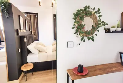 a bedroom and a living room with a mirror and a table at Ninho 424 in Porto