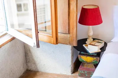 a lamp on a table next to a window at Rosarinho Cruz invites to her Atelier by the River in Porto