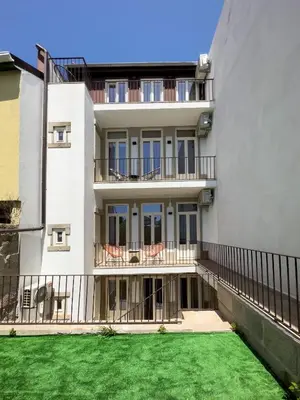 an apartment building with a lawn in front of it at Vibrant Host -Bonfim in Porto
