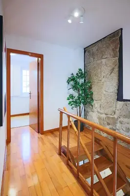 a room with a staircase and a stone wall at HM - Ribeira Historical Apartment in Porto