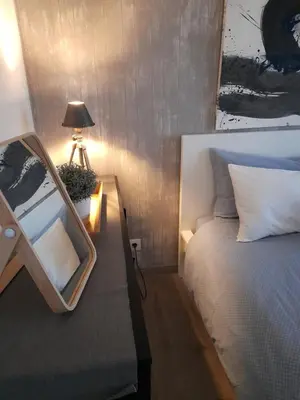 a bedroom with a bed and a table with a lamp at BEST View DOURO PORTO Penthouse in Vila Nova de Gaia