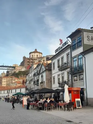 a group of people sitting at tables on a city street at BEST View DOURO PORTO Penthouse in Vila Nova de Gaia