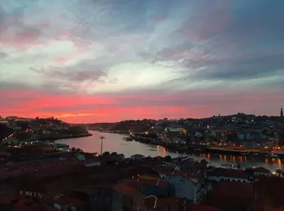 a view of a river in a city at sunset at BEST View DOURO PORTO Penthouse in Vila Nova de Gaia