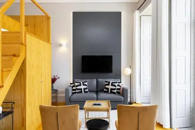 a living room with a couch and a tv at WHome Central 1-Bed w/ Top View perfect to Explore Porto in Porto