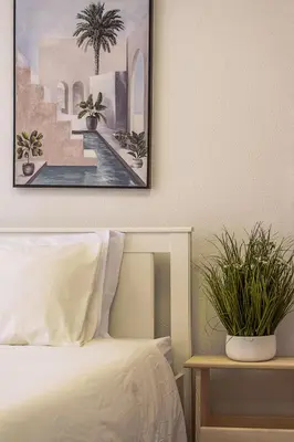 a bedroom with a bed and a picture on the wall at Travel & Live Fernão Magalhães in Porto