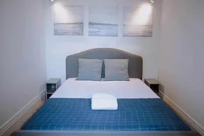 a bedroom with a bed with a blue and white at Porto Apartments in Porto