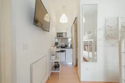 a room with a hallway with white walls and a mirror at Moinho de Vento Studios in Porto