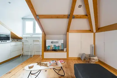 a living room with a table and a kitchen at GuestReady - Freixo Paradise view in Porto