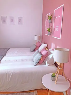 a bedroom with a white bed with pink walls at Cozy 3 room apartment near House of Music in Porto