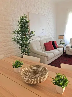 a living room with a couch and a table at Cozy 3 room apartment near House of Music in Porto