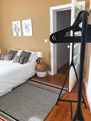 a bedroom with a bunk bed and a black ladder at Cozy 3 room apartment near House of Music in Porto