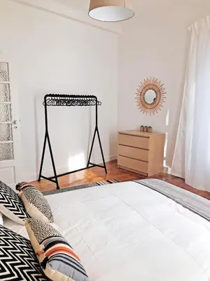 a bedroom with a bed and a mirror on the wall at Cozy 3 room apartment near House of Music in Porto