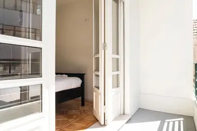 a room with a door leading to a bedroom at Charmant appartement climatisé avec balcons in Porto