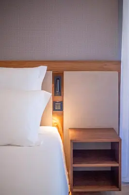 a bedroom with a bed and a nightstand next to it at Alliança Suites 1909 - Porto in Porto